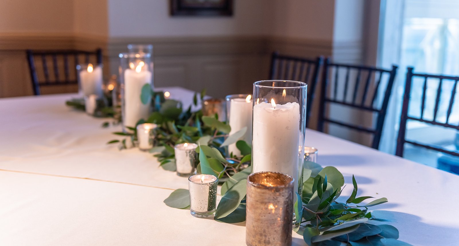 Beautiful elegant wedding table set up decorated with flower compositions and candles