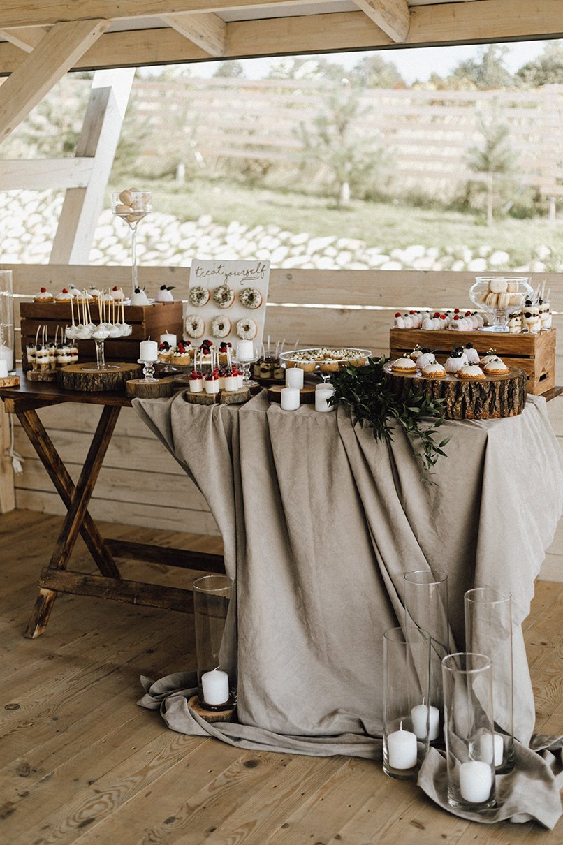Beautiful candy bar decorated in beige and white colors